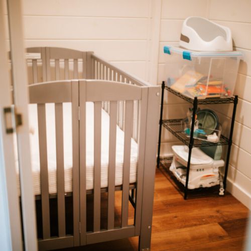 Unwind with Ease: A Serene Baby Nook for Ultimate Family Comfort, featuring a Full-Sized Crib, Newton Mattress, Baby Essentials, and Delightful Toys!