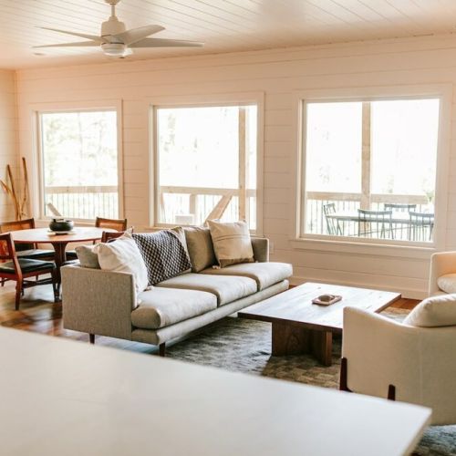 The lower-level lounge is a bright and airy space with a large wall of windows that provide similar views to those upstairs. There’s also a gas fireplace, a big-screen TV, and an heirloom game table with a small collection of fun games.