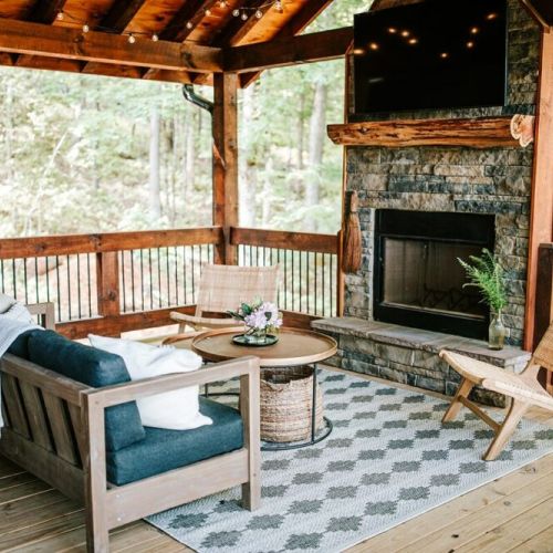 Settle in for a quiet evening by the outdoor wood-burning fireplace on main level porch.