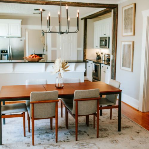 This dining area's open floor plan effortlessly connects with the kitchen, creating a spacious and inviting atmosphere for entertaining.