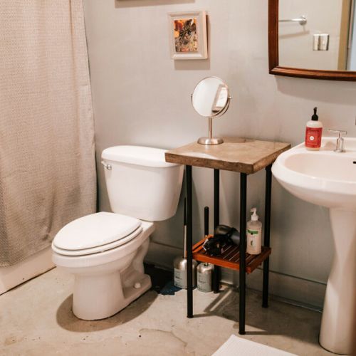 The loft features one bathroom with a pedestal sink and tub/ shower combination.