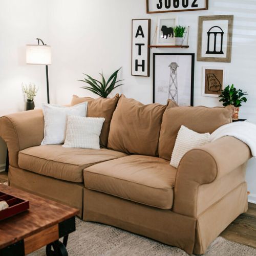 Cozy up on this inviting brown sofa, where warmth and comfort meet style.