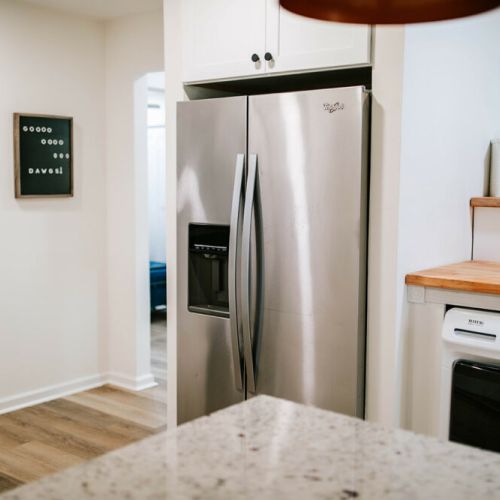 Modern convenience meets style in this kitchen, featuring a Whirlpool refrigerator with double doors for easy access and organization.