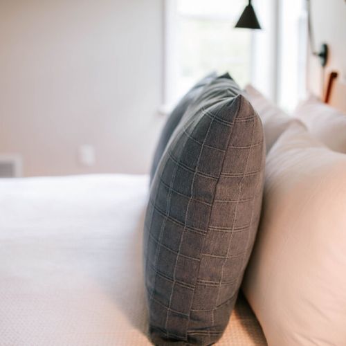 Layered in plush comfort, these textured pillows add a cozy and contemporary touch to your restful retreat.