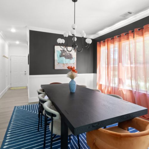 Host unforgettable dinners in this bold, stylish dining room—where moody walls, luxe textures, and playful pops of color create the perfect vibe.
