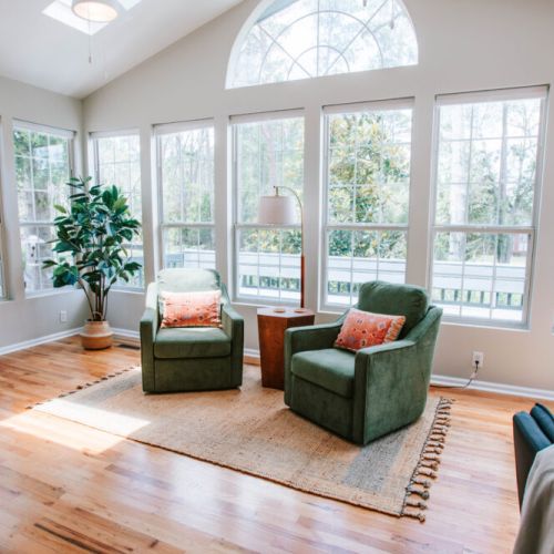 Soak up the sunshine in this cozy reading nook! With floor-to-ceiling windows, lush views, and comfy armchairs, it’s the perfect spot to sip your morning coffee or unwind with a good book.
