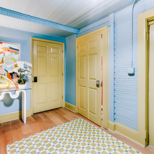 Arrive to a cheerful entryway where playful color, curated artwork, and warm wood floors set the tone for your stay. Thoughtful design details create a welcoming first impression and lead you into a home full of personality.