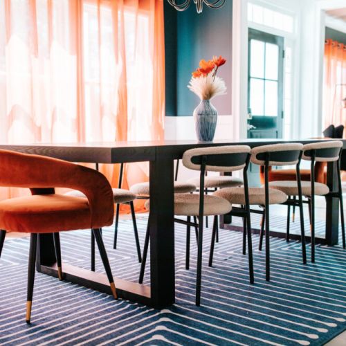 Gather 'round this chic, sun-soaked dining space—where bold colors meet modern vibes for meals that feel like events.
