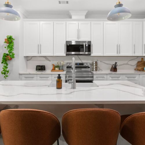 Whip up gourmet meals in this sleek, fully stocked kitchen—complete with luxe countertops, modern appliances, and serious style.