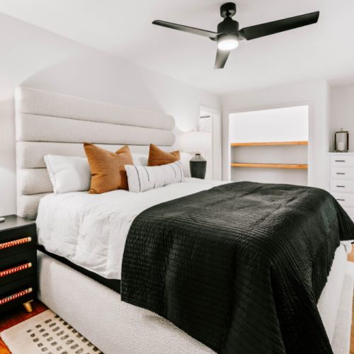 Inviting bedroom with a plush bed, modern décor, and plenty of storage space.