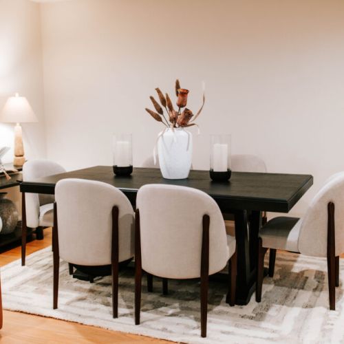 Gather in style — this elegant dining space features plush seating, warm lighting, and a modern touch, perfect for intimate dinners or lingering conversations over wine.
