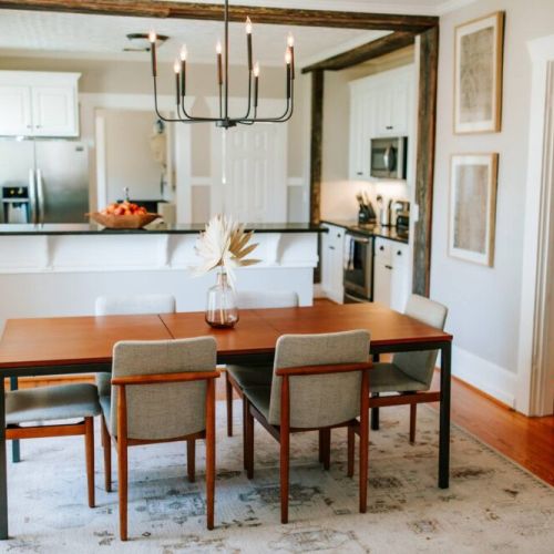 This dining area's open floor plan effortlessly connects with the kitchen, creating a spacious and inviting atmosphere for entertaining.