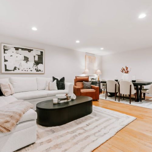 Bright and stylish living area with a cozy sofa, modern décor, and dining space perfect for gathering.