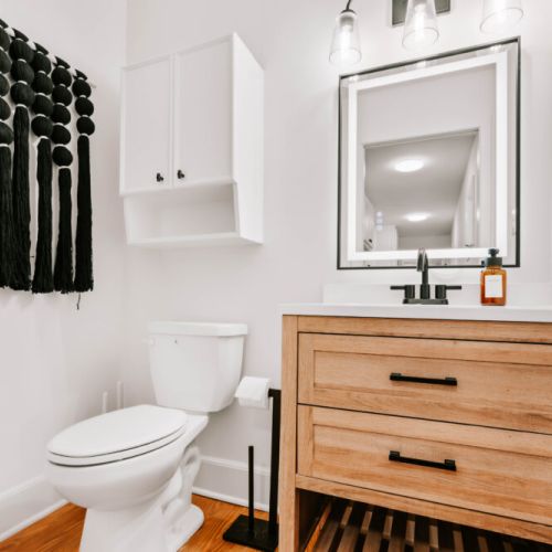 Stylish bathroom with sleek finishes and warm wood accents — a relaxing space to refresh during your stay.
