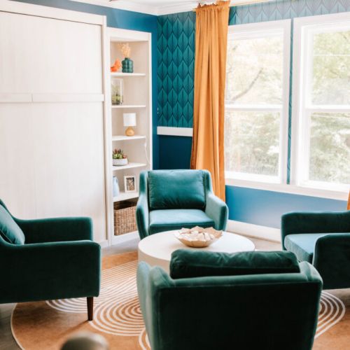 This stylish sunlit lounge blends glam decor with cozy vibes—perfect for morning coffee, game night, or an impromptu photoshoot!
