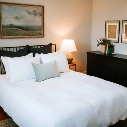 Each bedroom boasts a cozy queen-sized bed, complete with a Purple mattress and organic cotton sheets for the ultimate comfort.