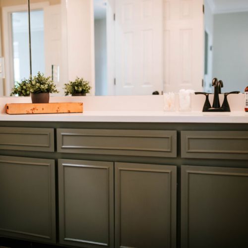 Modern charm meets function with this elegant vanity. Featuring rich sage cabinetry, sleek matte black hardware, and a spacious countertop ideal for everyday essentials.