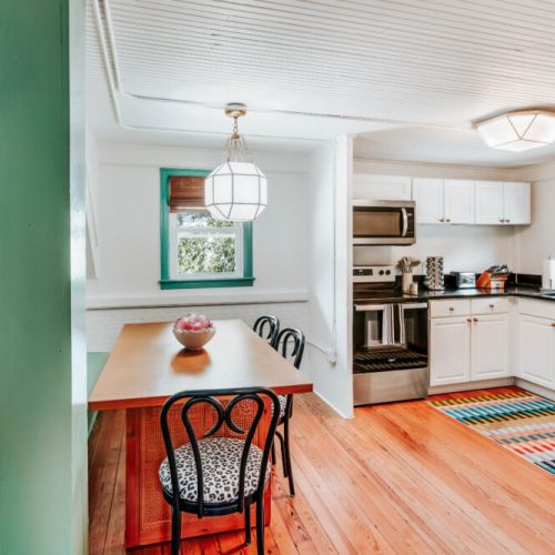 Gather for meals and morning coffee in this bright dining space, just steps from the well-equipped kitchen. Stainless steel appliances, generous counter space, and colorful details make dining in feel easy, inviting, and part of the experience.