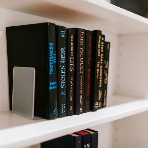 A curated bookshelf with popular novels and thrillers, offering the perfect way to unwind with a good read during your stay.