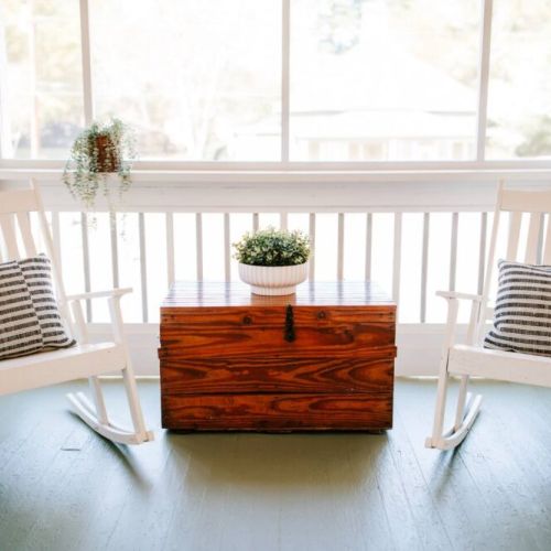 Relax and unwind: this porch is furnished with comfortable chairs, inviting you to sit back, relax, and enjoy.