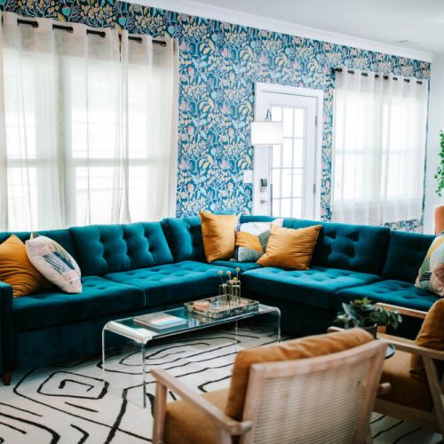 Lounge in luxe on this plush velvet sectional, surrounded by lush wallpaper and natural light. A stylish escape made for cozy hangs and photo ops!