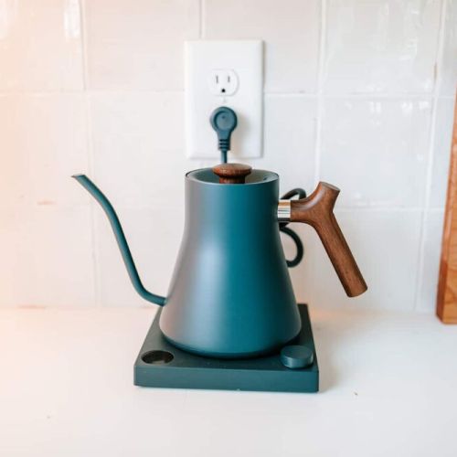Elevate your coffee game: this kitchen is equipped with a Fellow Stagg Kettle, perfect for coffee lovers looking to brew the perfect cup with precision and style.