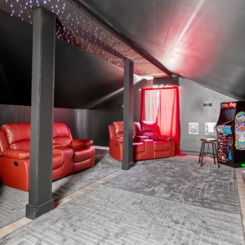 Lights, camera, relax! This cozy hideaway brings the cinema home with plush recliners, a massive screen, and even an arcade corner for a dose of retro fun. Perfect for family nights, gamer getaways, or binge-watching marathons.