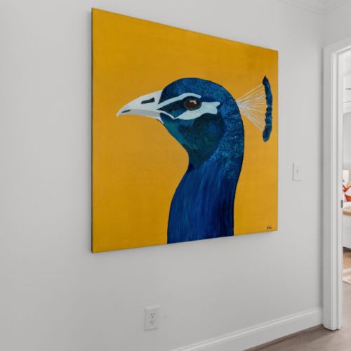 Bold art, bright vibes—this hallway stuns with a pop of color and personality that hints at the style waiting just beyond the door.