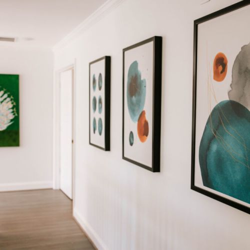 Bold colors, striking art, and modern vibes—this hallway is a gallery in your getaway.
