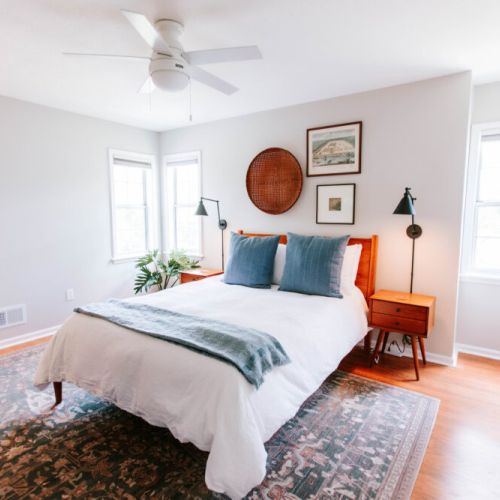 Bask in the natural light of this airy bedroom, where calming tones, plush textures, and curated vintage touches create the perfect space to rest and recharge.