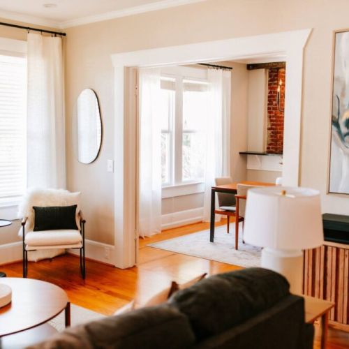 The open floor plan and beautiful natural light flowing in through the large windows make the kitchen and living room the perfect place to hang out as a whole family or group.