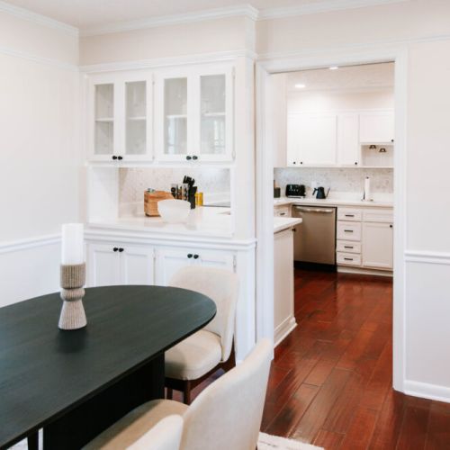 Bright dining flow into a pristine kitchen designed for effortless hosting.