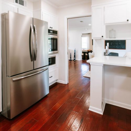 Sleek stainless appliances and warm wood floors highlight this kitchen.