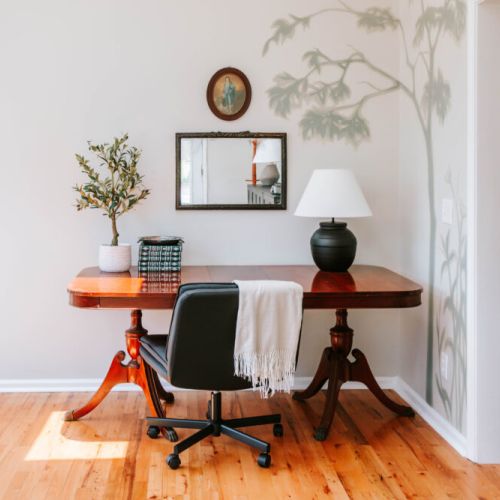 A peaceful corner for work or reflection made even more special with a hand-painted mural by talented local artist Meredith Raiford, bringing nature’s calm right indoors.