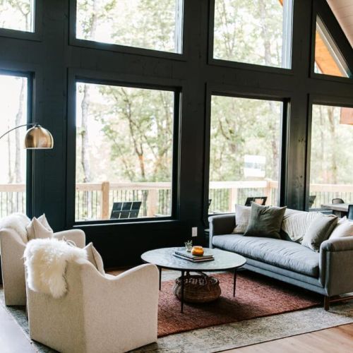 The main-level living room boasts massive floor-to-ceiling windows, which allow you to take in the incredible mountain views from the comfort of the sofa or plush chairs.