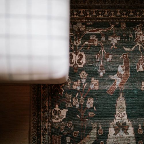 Charming vintage-style rug adds a cozy, artistic touch to the space—thoughtfully curated for a warm and welcoming stay