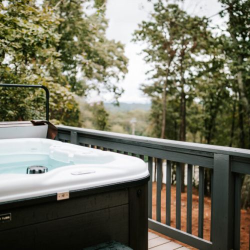 Relax in the private hot tub while enjoying peaceful wooded views.