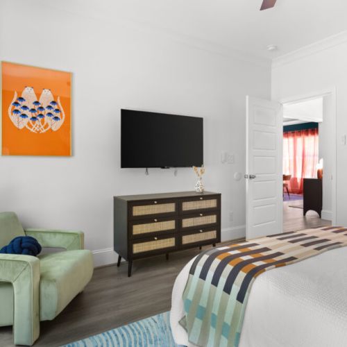 Kick back in style with bold art, a plush chair, and your favorite shows—this cozy corner was made for lounging.