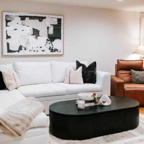 Relax in the sophisticated living room, where plush seating, modern design, and cozy touches create the perfect space to unwind or gather with loved ones.