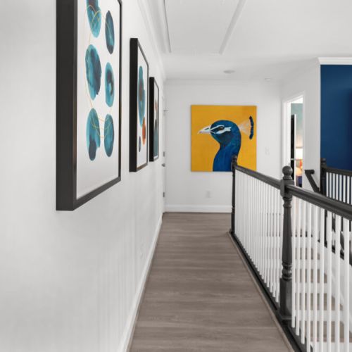 Bold colors, striking art, and modern vibes—this hallway is a gallery in your getaway.