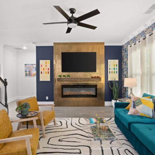 Snuggle up by the sleek electric fireplace, sink into plush velvet sofas, and soak in the natural light dancing off bold, vibrant décor. Whether you're binge-watching on the big screen or sipping wine under soft-glow lighting, this living room is the perfect vibe for your getaway.