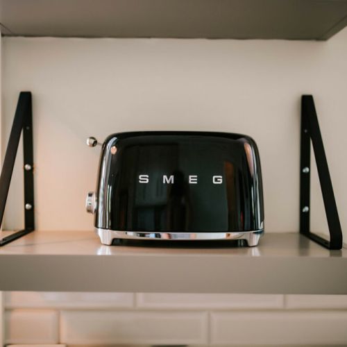 Toast to perfection! Our fully equipped kitchen includes a Smeg toaster, adding a touch of retro charm to your culinary experience.