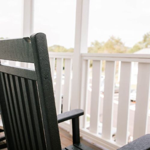 The upstairs porch features rocking chairs for you to enjoy peaceful time outside.
