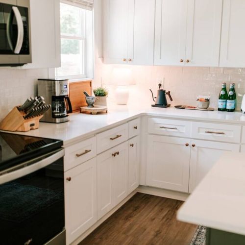The luxurious kitchen is complete with stainless steel appliances and an island with seating for three, perfect for socializing with friends and family while creating delicious meals.