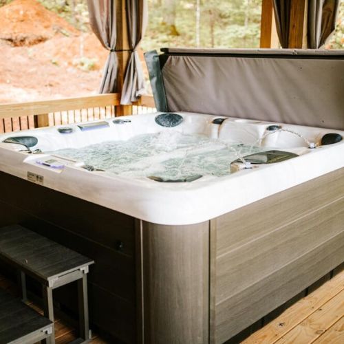 We invite you to relax in the bubbling hot tub on our lower level porch!
