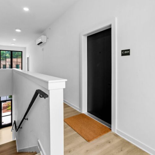 Bright, modern entryway leading to your private retreat. Easy access with secure, well-lit hallways for your comfort and convenience.