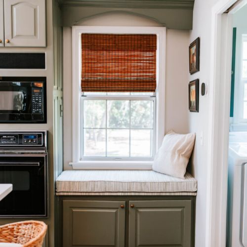 Tucked right between the kitchen and laundry, this cozy little bench is perfect for morning coffee, cookbook browsing, or just soaking in the sunshine.