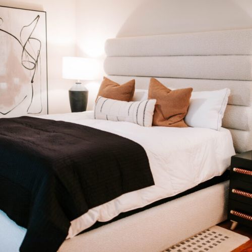 Retreat to a bedroom designed for rest and style — with a plush bed, layered textures, and soft lighting, it’s the perfect place to unwind and recharge in comfort.