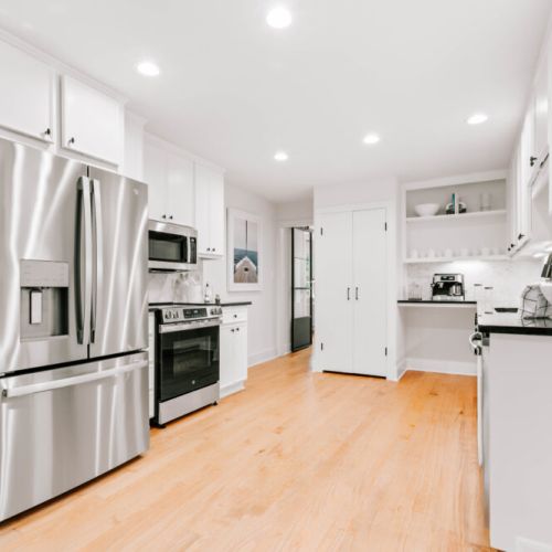 Modern kitchen with stainless steel appliances, ideal for cooking and sharing meals together.