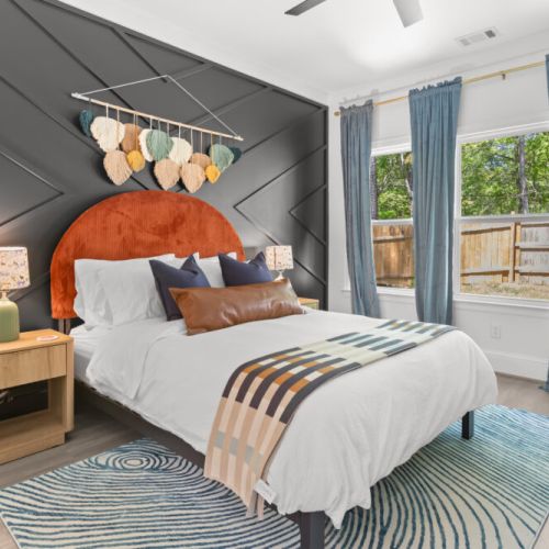 Wake up refreshed in this design-forward sanctuary featuring a statement wall, luxe linens, and tons of natural light. With earthy textures, playful pops of color, and peaceful views, this room is your dreamy retreat after a day of exploring.